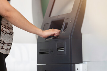 woman's hand on ATM transferring money or withdraw money