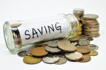 Saving lable in a glass jar with coins spilling out