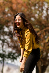 latina girl smiles on an autumn day