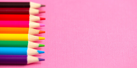 Set of Rainbow Colored Pencils on a Bright Pink Background
