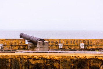 Cannons of the old fort Orange - Itamaracá - Cloudy sky with a view of the island of Coroa do Avião