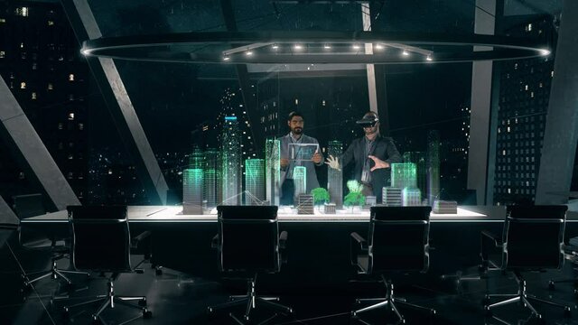 In the Near Future: Professional Designer in Suit wearing AR Headset presenting Architecture Project to Partner standing around Futuristic Table with Holographic Modern Augmented Reality Technology.