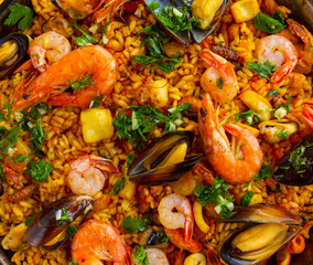 Close-up of Traditional spanish seafood paella with rice, mussels, shrimps. view from above, flat lay