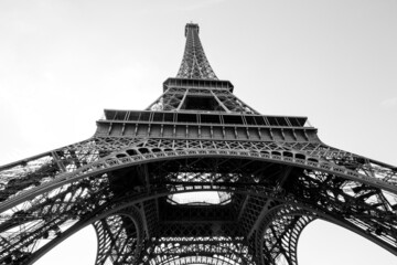 black and white eiffel tower seen from below on a cloudless background