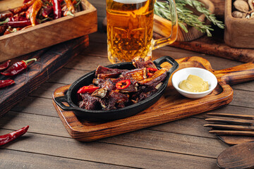 Roast lamb ribs with pepper and mustard on a wooden background