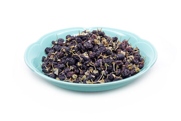 Black wolfberry in ceramic dish isolated on white background. commonly known as black fruit wolfberry, goji nero, siyah goji. Used in traditional Chinese medicine, herbal tea