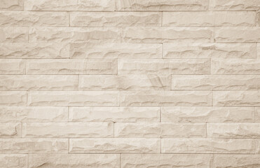 Empty background of wide cream brick wall texture. Beige old brown brick wall concrete or stone textured.