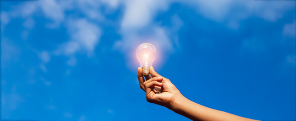 Hand holding light bulb,natural energy and love the world concept.