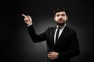 Businessman pointing finger forward and up