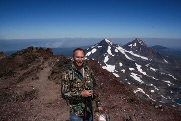 adult man summiting south sister in Oregon