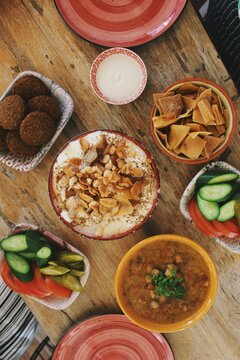 Closeup image of Palestinian cuisine food, fatteh & falafel, fol on plate arrangement in kitchen