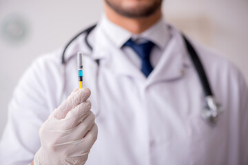 Young male doctor in vaccination concept