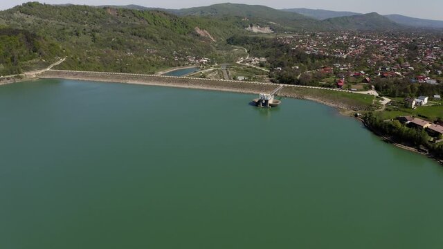 Aerial View Of Calm Waters Of Maneciu Dam In Prahova County, Romania. dolly-in drone, tilt down