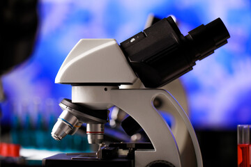 Closeup shot of microscope with selective lens objectives for various magnification or observation scales used as apparatus in microbiology lab for physical substance research and cell study.