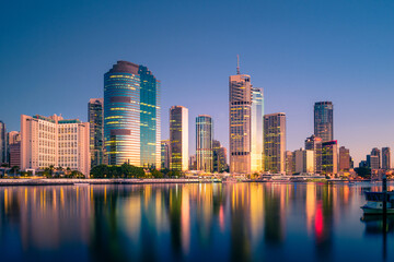Brisbane city buildings and waterfront at sunrise as seen from across the river. Brisbane is the state capital of Queensland, Australia.
