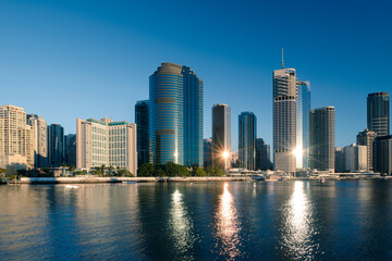 View of Brisbane city buildings and river seen in early morning light. Brisbane is the state capital of Queensland, Australia.