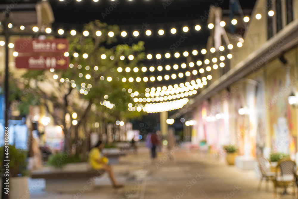 Poster abstract blur image of night festival with a street walk and led light on tree bokeh for background