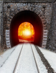 A Railroad tunnel from winter to Autumn landscape