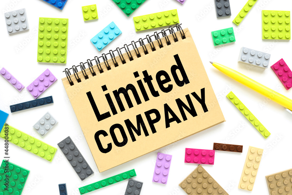 Poster limiting company, text on a craft notebook near the constructor of different colors