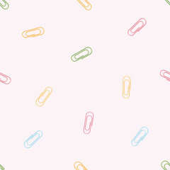 Seamless patter in cartoon flat style of multi-coloured paper clip isolated on a pink background. Vector illustration. 