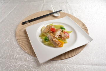 stir fried celery vegetable with fish meat paste in chef special sauce in white background asian halal vegan menu