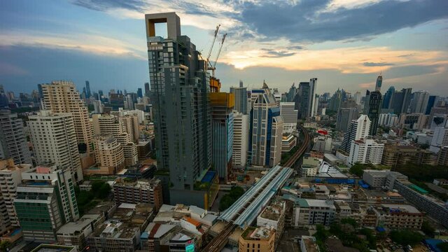 Aerial view of Siam Bangkok intersection or junction with cars traffic skyscraper buildings. Bangkok City in downtown at night, Thailand. 
