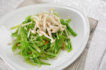 stir fried dragon vegetable with white mushroom vegetarian in soy sauce in white background asian halal vegan menu