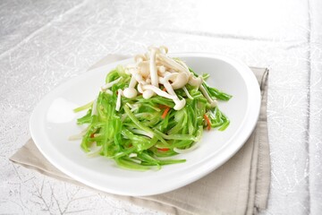 stir fried dragon vegetable with white mushroom vegetarian in soy sauce in white background asian halal vegan menu