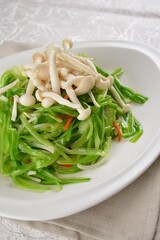 stir fried dragon vegetable with white mushroom vegetarian in soy sauce in white background asian halal vegan menu
