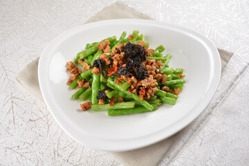 stir fried green long bean vegetables with mini shrimp paste and garlic in white background asian halal vegan menu