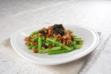 stir fried green long bean vegetables with mini shrimp paste and garlic in white background asian halal vegan menu