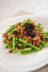 stir fried green long bean vegetables with mini shrimp paste and garlic in white background asian halal vegan menu