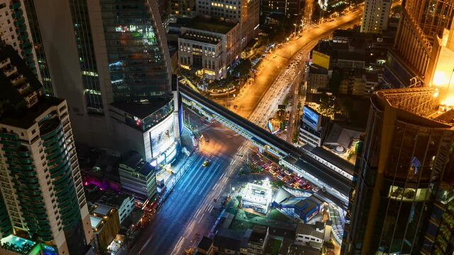 Time lapse of aerial view of Asoke intersection or junction with cars traffic, Bangkok Downtown. Thailand. Financial district in smart urban city and technology concept.
