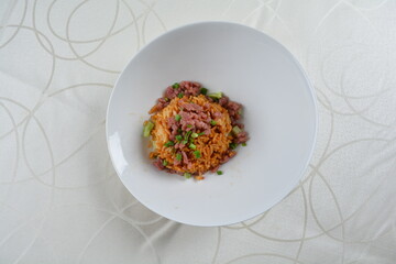 egg fried rice with black truffle, meat and seafood in dark sauce in white background asian halal vegan menu