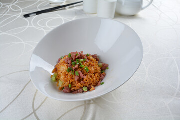 egg fried rice with black truffle, meat and seafood in dark sauce in white background asian halal vegan menu