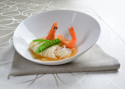 braised handmade thin noodle udon ramen with prawn and vegetable in premium stock soup in white background asian halal vegan menu