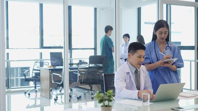 Doctor brainstorming examination of the symptoms patient at meeting room. Medical team presenting symptoms of patient at hospital.