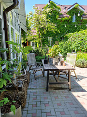 country house with panoramic windows and a table for lunch in the summer garden.