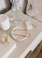 Flatlay of bedside table with jewelry and hair accessories