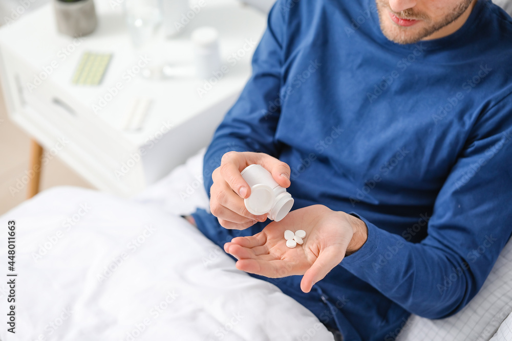 Sticker handsome young man taking pills in bedroom