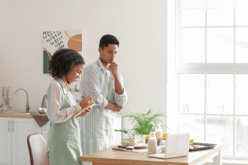 African-American brother and sister making cookies in kitchen