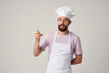 emotional male chef in a white apron is trying food