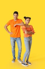 African-American brother and sister on color background