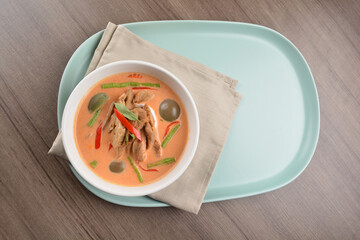 thai spicy chili red curry hot soup with vegetarian meat in bowl blue plate on wood background asian halal vegan menu