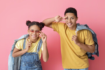 Obraz premium African-American brother and sister on color background