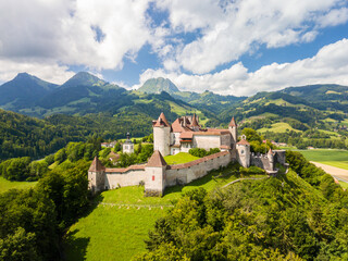 The aerial image of the medieval Gruyeres Castle on the hill top of Alps. It is one of the most...