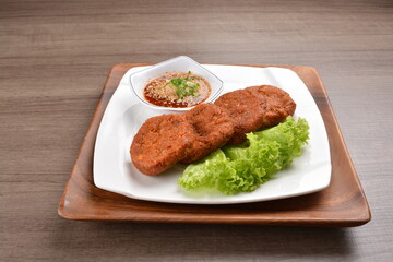 deep fried hash brown round potato cake with Thai spicy chilli sauce on wood background asian halal vegan menu