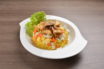 vegetarian nasi goreng fried rice with pineapple, vegetables meat in spicy chilli sambal sauce on wood background asian halal vegan menu