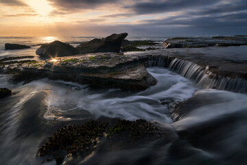 water flowing on the rocks at the beach