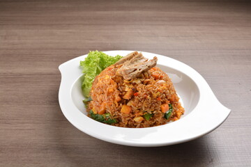 vegetarian nasi goreng fried rice with pineapple, vegetables meat in spicy chilli sambal sauce on wood background asian halal vegan menu